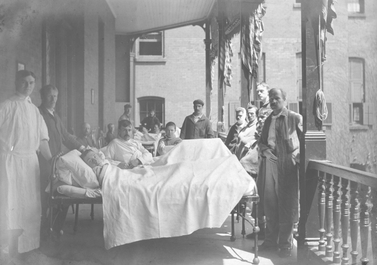 Patients, personnel et visiteurs sur le balcon de l’aile M de l’HGM, 1905