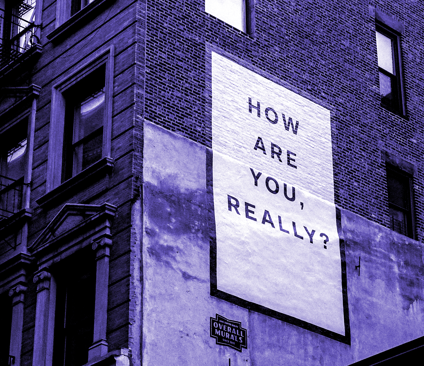 Mur d'édifice présentant une mural où il est écrit : "How are you, really?"